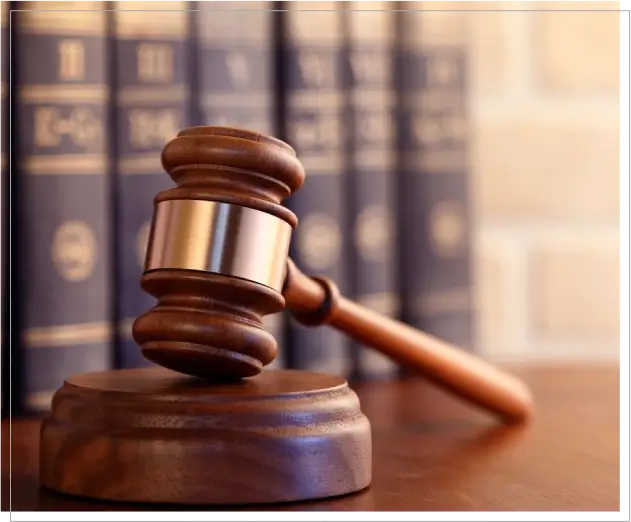 A wooden gavel sitting on top of a table.